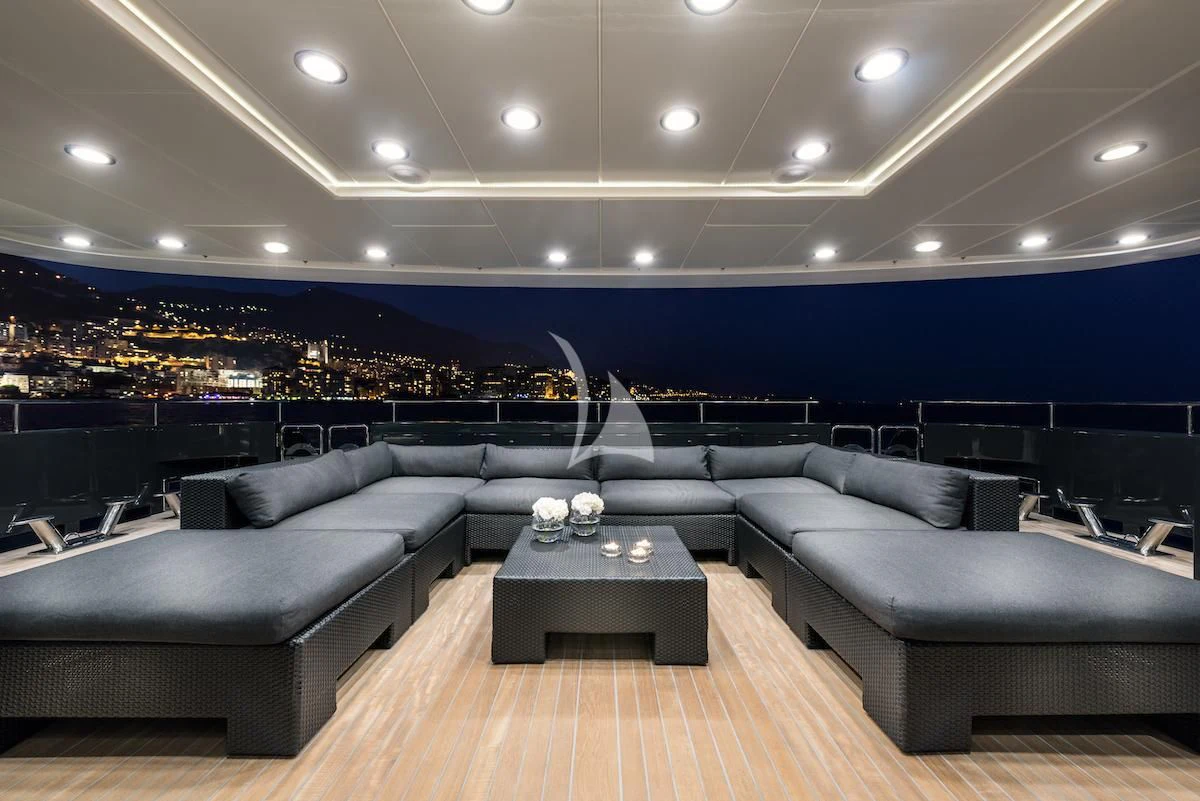 a living room with a large blue wall and a large window aboard THANUJA Yacht for Sale