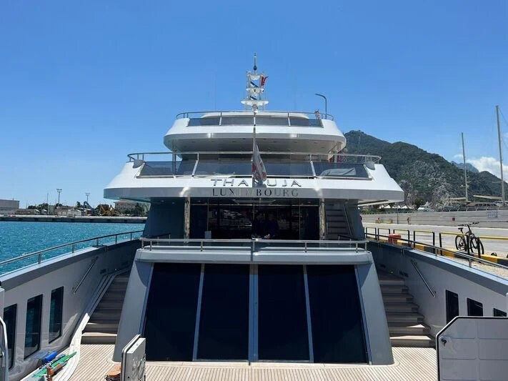 a large boat docked at a pier aboard THANUJA Yacht for Sale