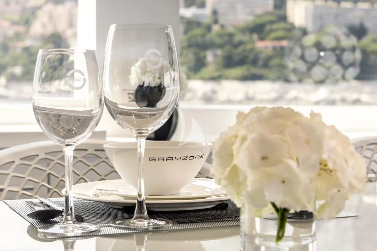 a table with wine glasses and flowers aboard THANUJA Yacht for Sale