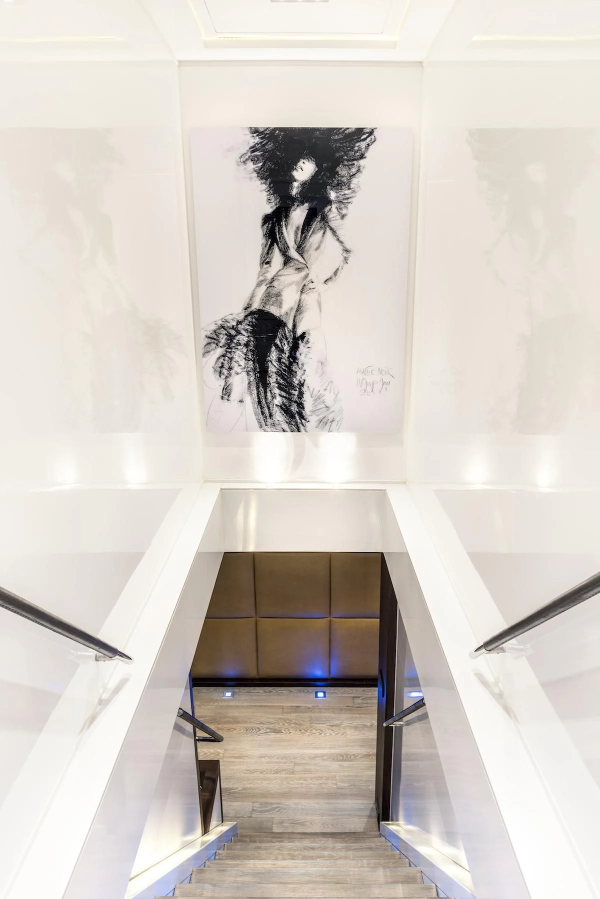 a staircase with a painting on the wall aboard THANUJA Yacht for Sale