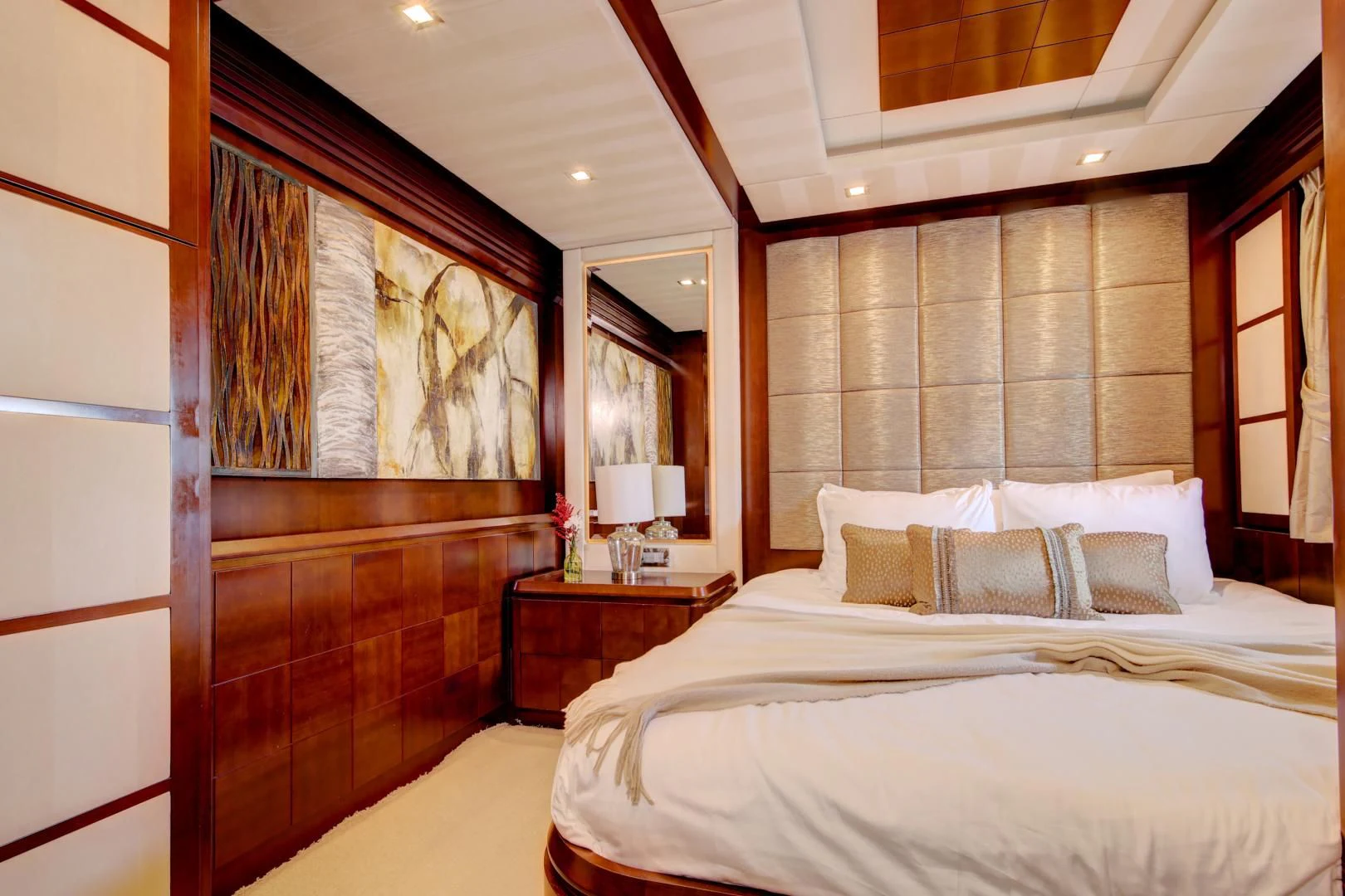 a room with a bed and a mirror aboard SORRIDENTE Yacht for Sale