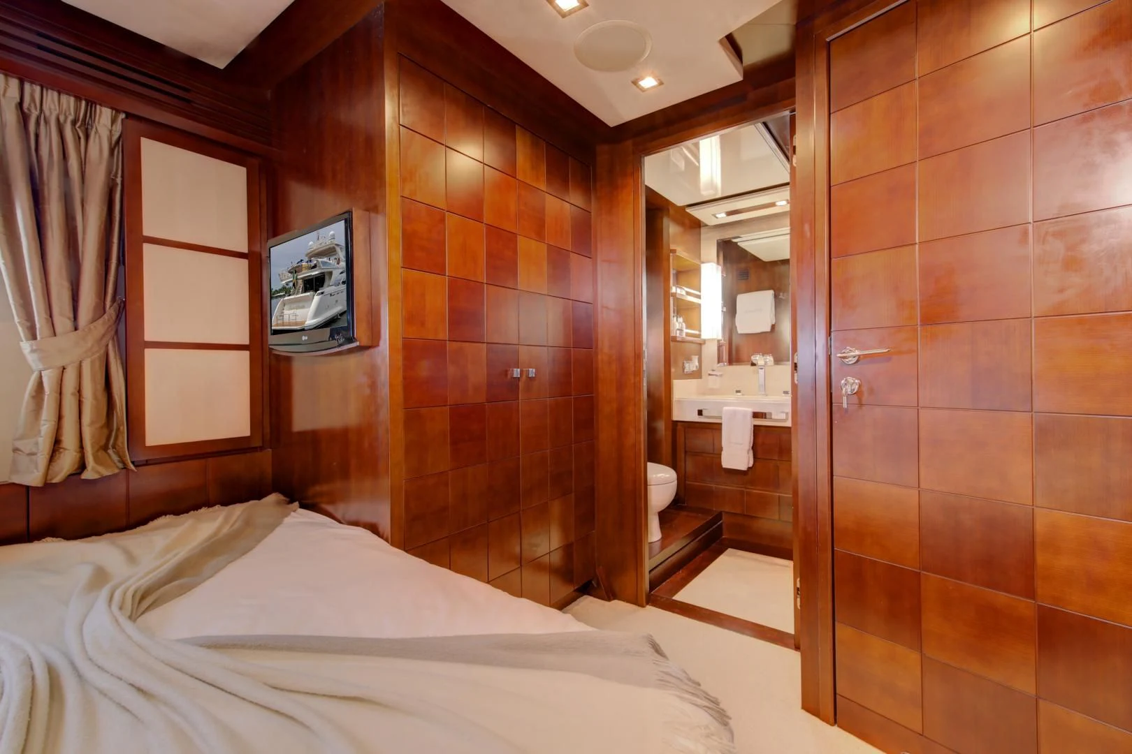 a bedroom with a bed and a mirror aboard SORRIDENTE Yacht for Sale