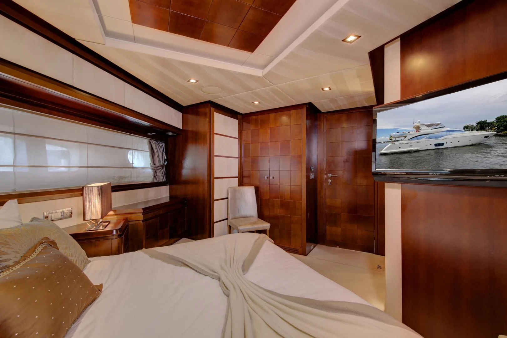 a room with a bed and a wood wall aboard SORRIDENTE Yacht for Sale