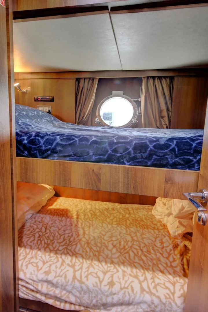 a bed with a mirror above it aboard SORRIDENTE Yacht for Sale