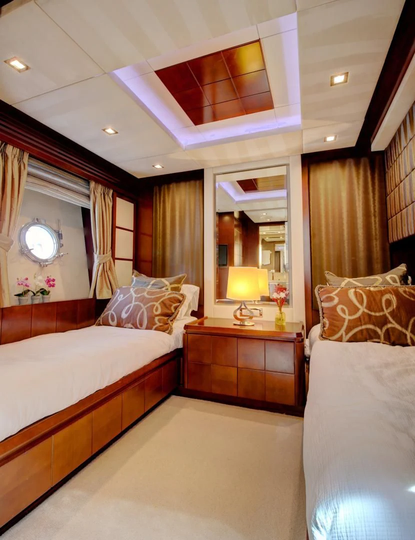 a bedroom with a bed and a mirror aboard SORRIDENTE Yacht for Sale