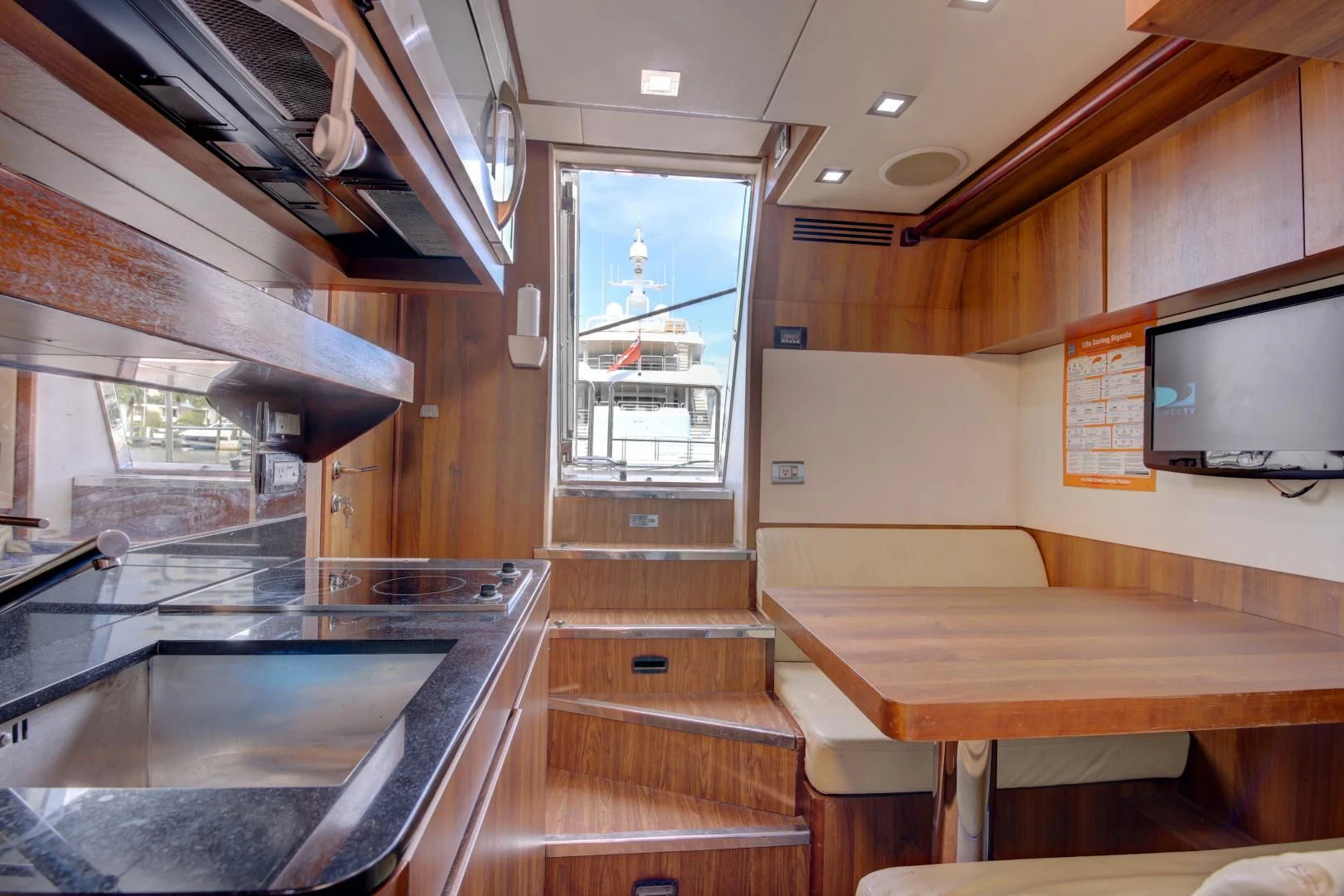 a room with wood floors and a large window aboard SORRIDENTE Yacht for Sale