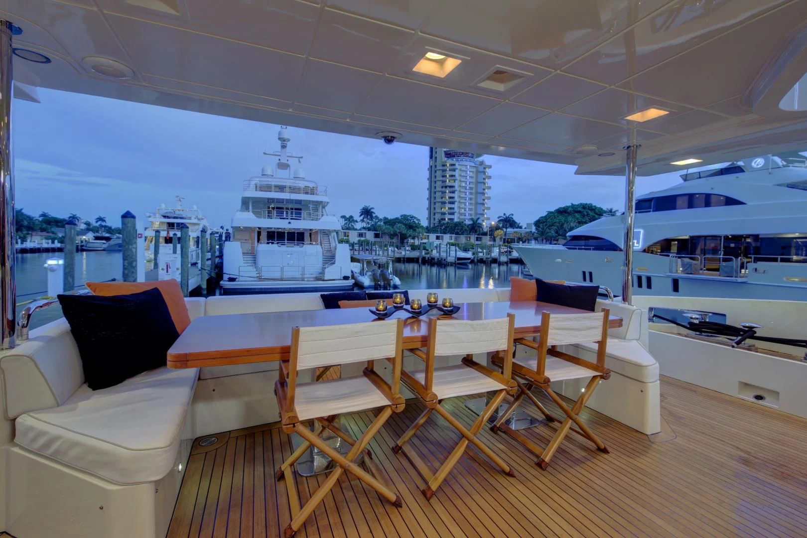 a room with a table chairs and a view of a city aboard SORRIDENTE Yacht for Sale
