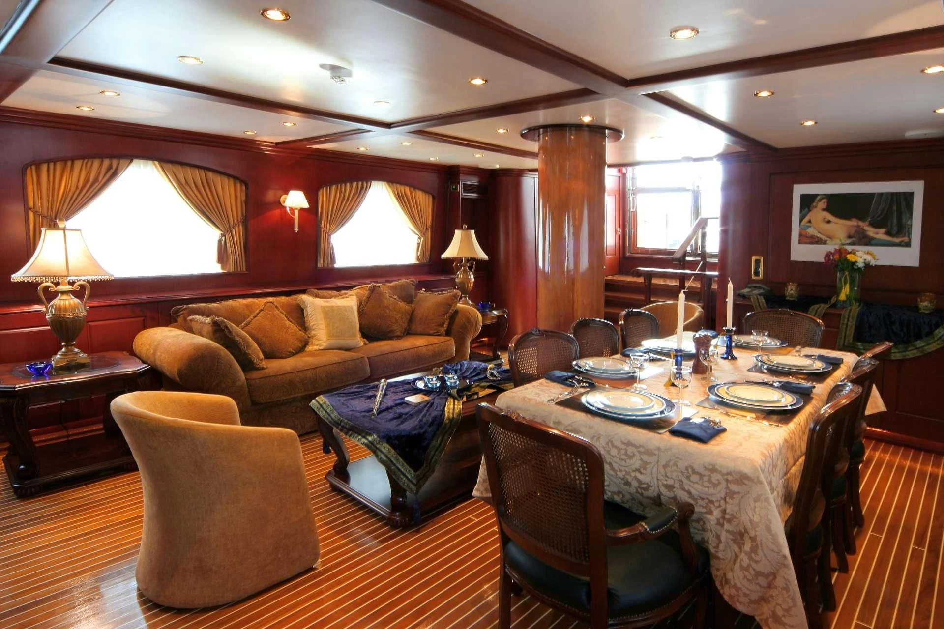a large living room with a dining table and chairs aboard BLUE DREAM Yacht for Sale