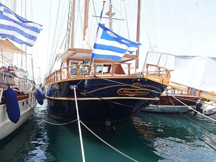 a boat with a flag on it aboard BLUE DREAM Yacht for Sale