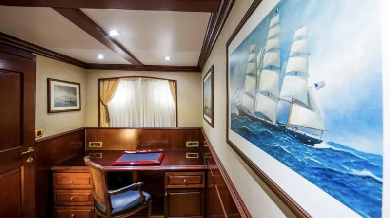 a room with a desk and a large blue screen aboard BLUE DREAM Yacht for Sale