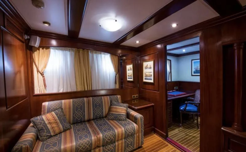 a living room with a couch and a table aboard BLUE DREAM Yacht for Sale
