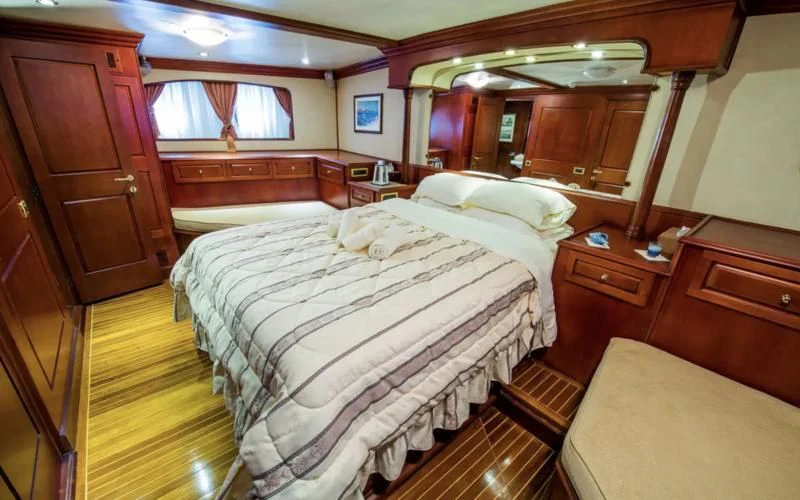 a room with a couple of beds aboard BLUE DREAM Yacht for Sale
