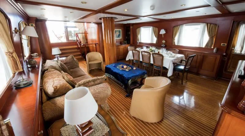 a living room with a couch and a table aboard BLUE DREAM Yacht for Sale