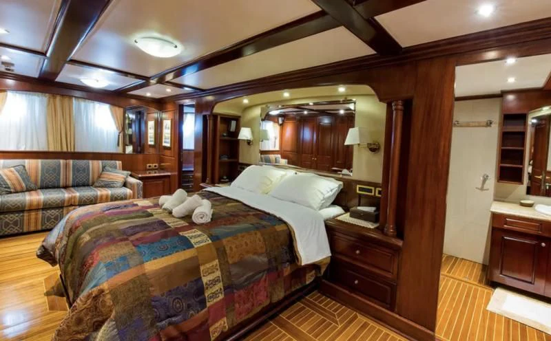 a bedroom with a bed and a couch aboard BLUE DREAM Yacht for Sale