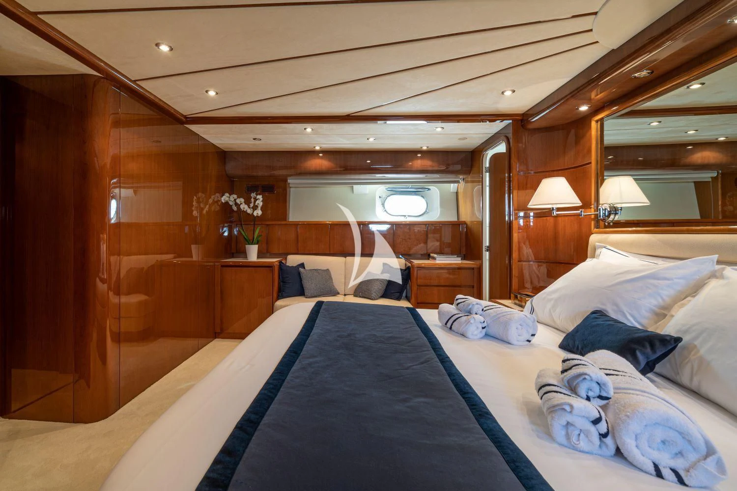 a bed with a blue sheet aboard ESTIA POSEIDON Yacht for Charter