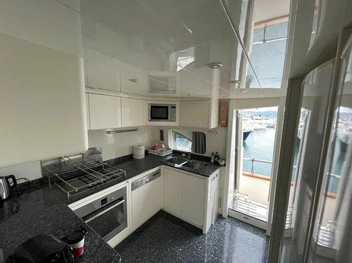 a kitchen with a sliding glass door aboard ESTIA POSEIDON Yacht for Charter