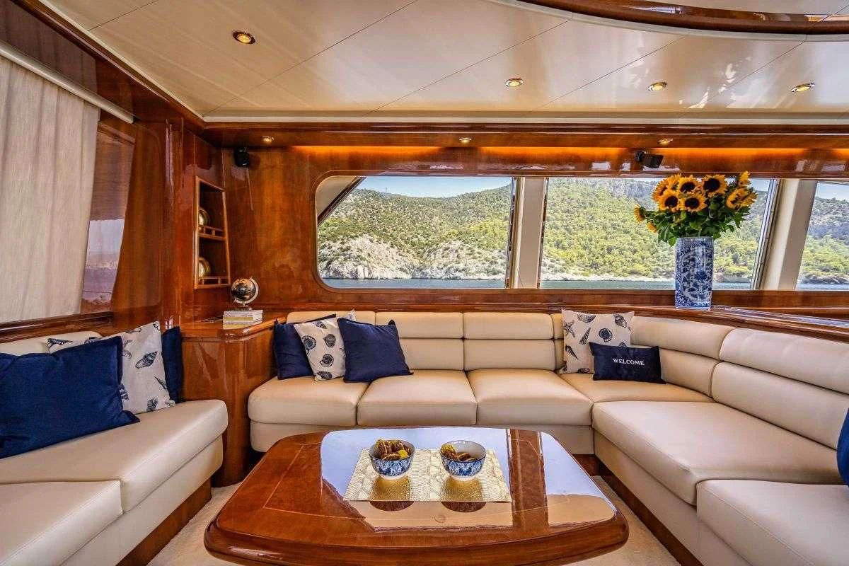 a living room with a couch and a table aboard ESTIA POSEIDON Yacht for Charter