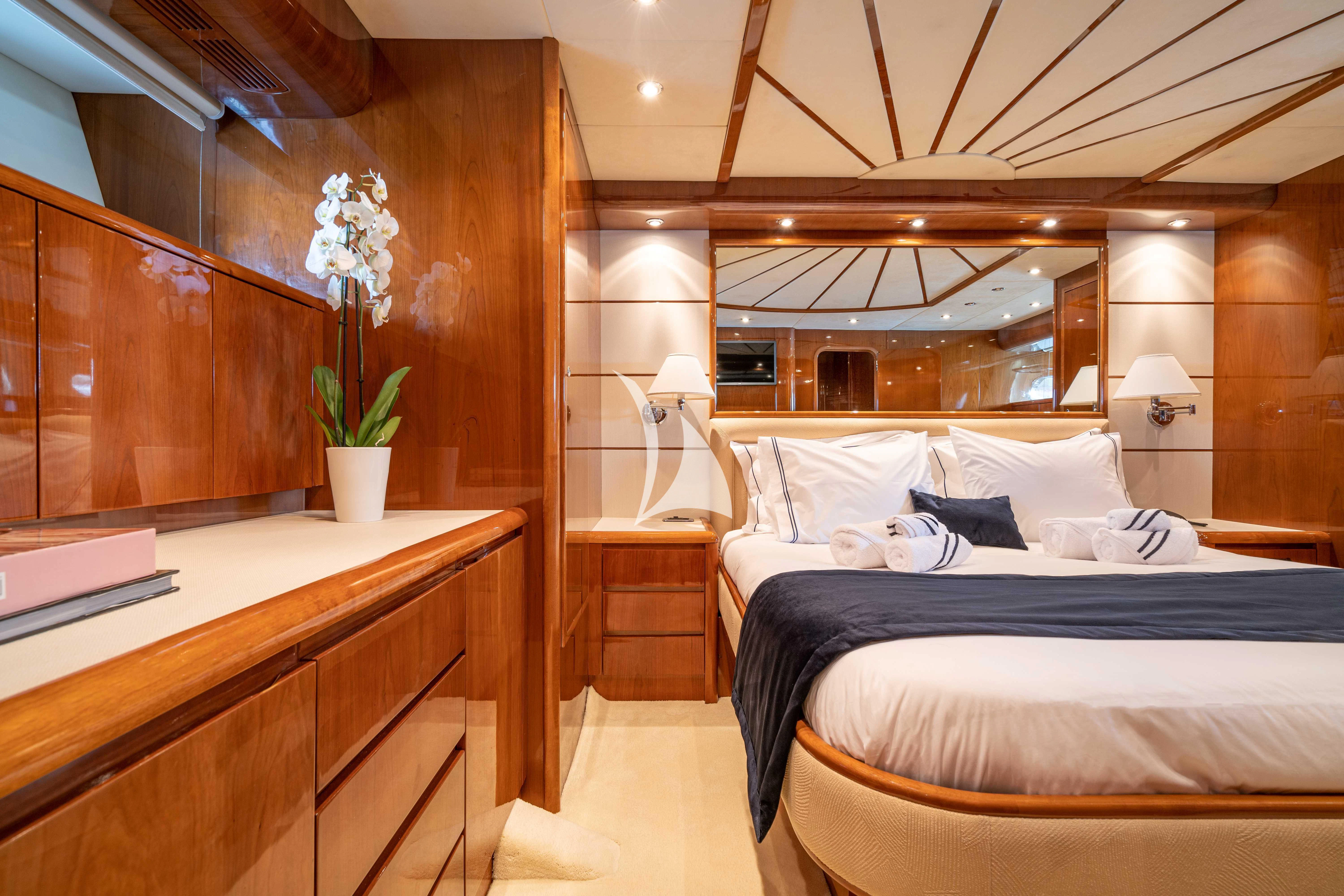 a room with a bed and a desk aboard ESTIA POSEIDON Yacht for Charter