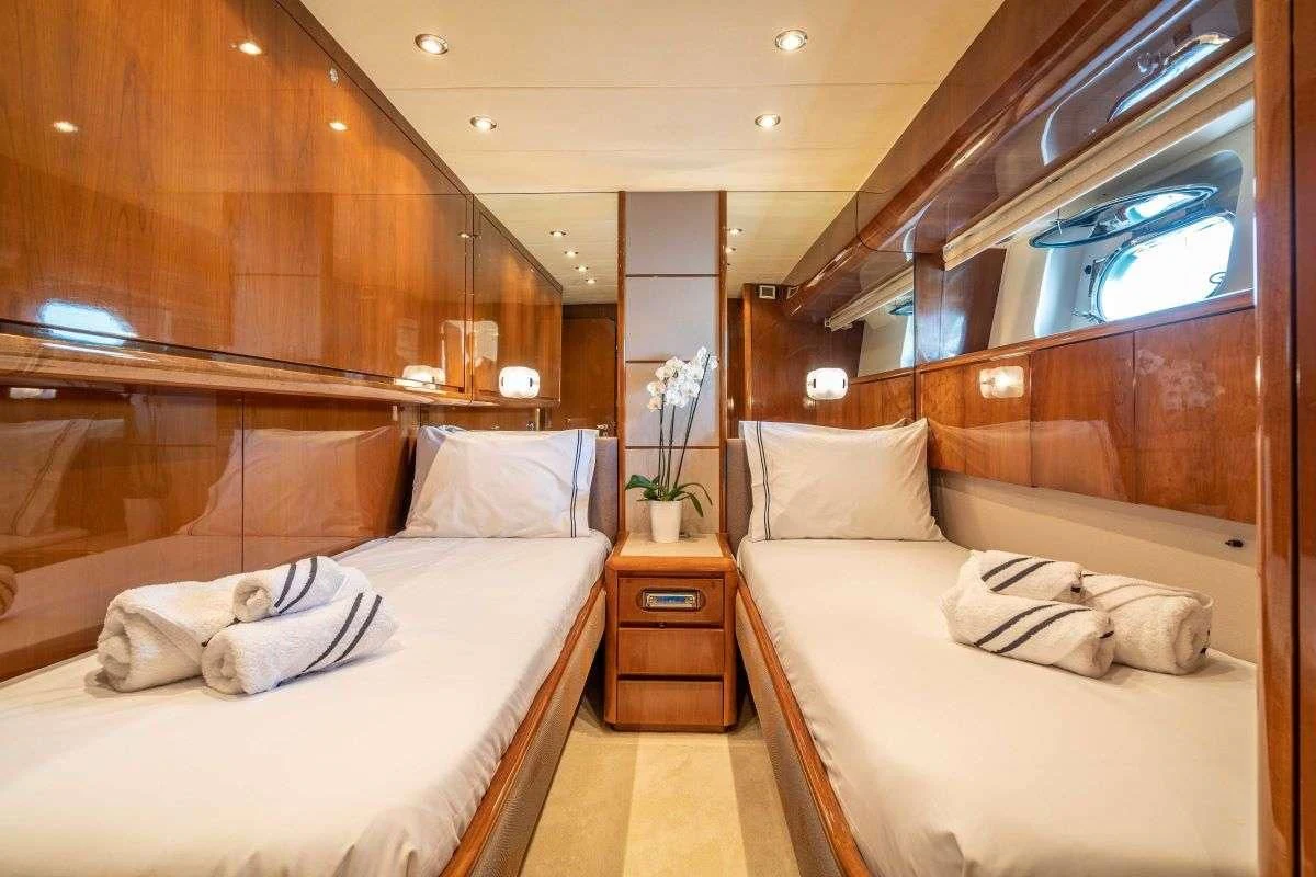 a room with a bed and a mirror aboard ESTIA POSEIDON Yacht for Charter