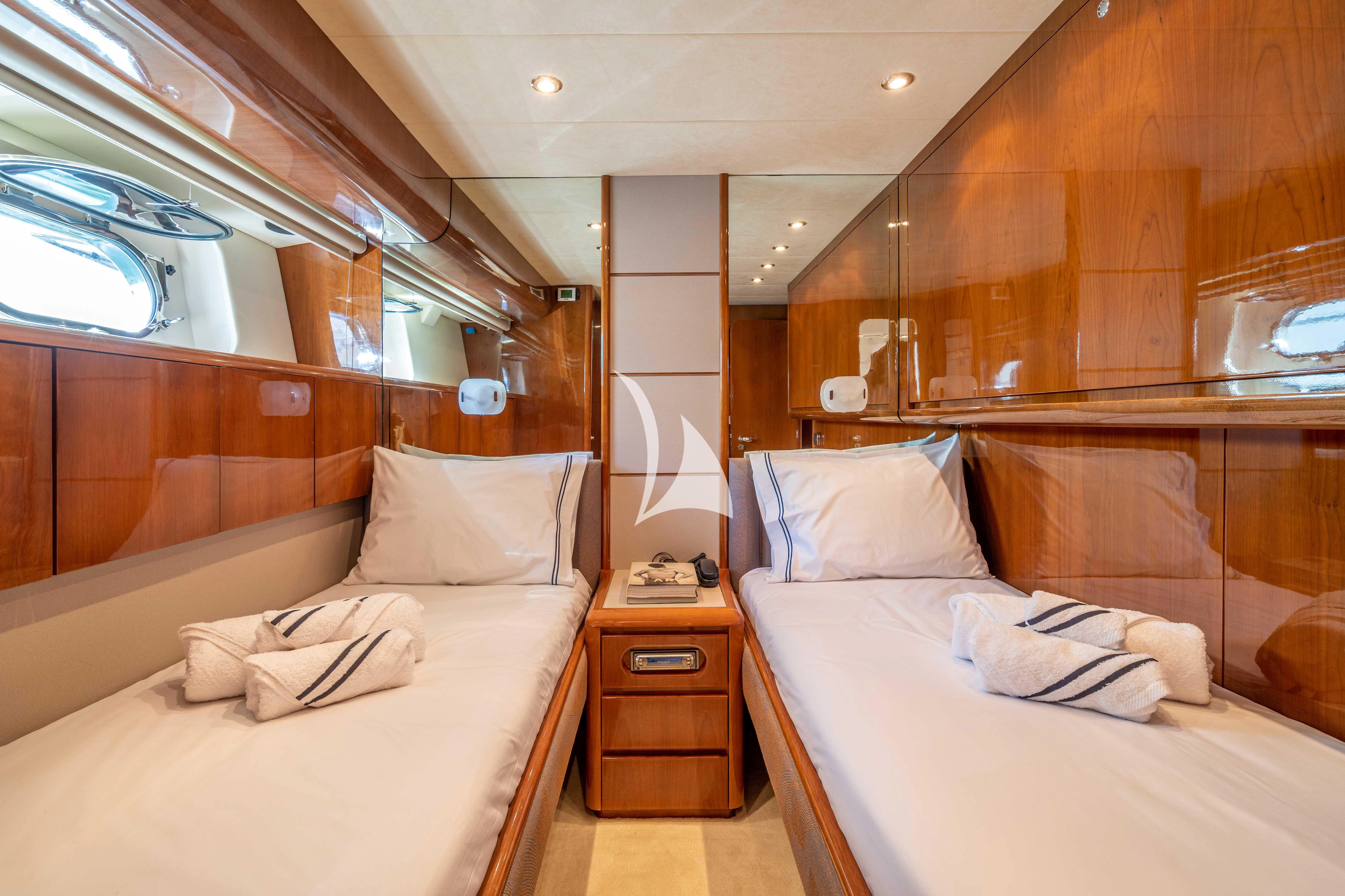 a room with a bed and a dresser aboard ESTIA POSEIDON Yacht for Charter