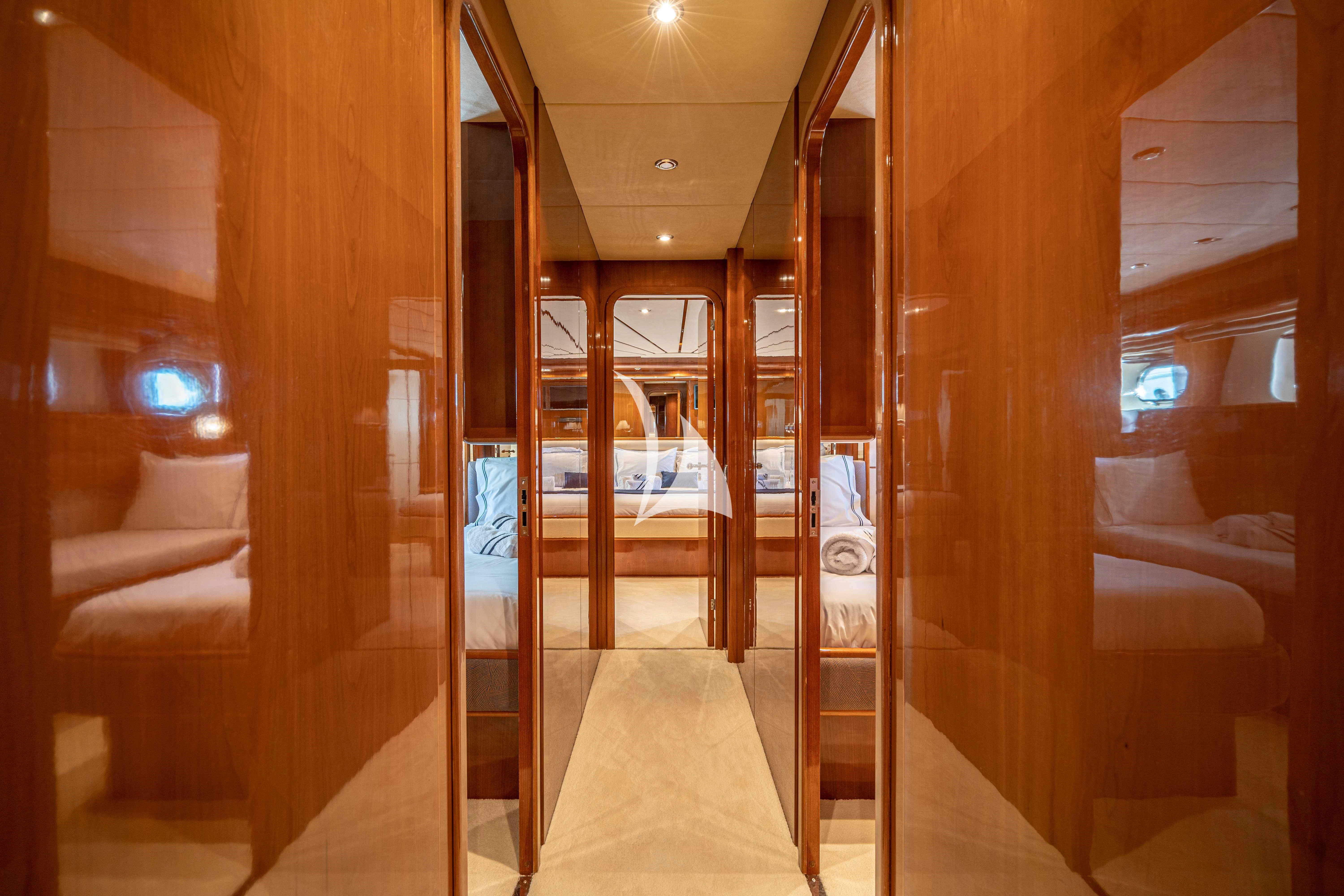 a room with a bed and a door aboard ESTIA POSEIDON Yacht for Charter