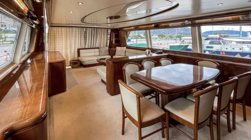 a room with tables and chairs aboard ESTIA POSEIDON Yacht for Charter