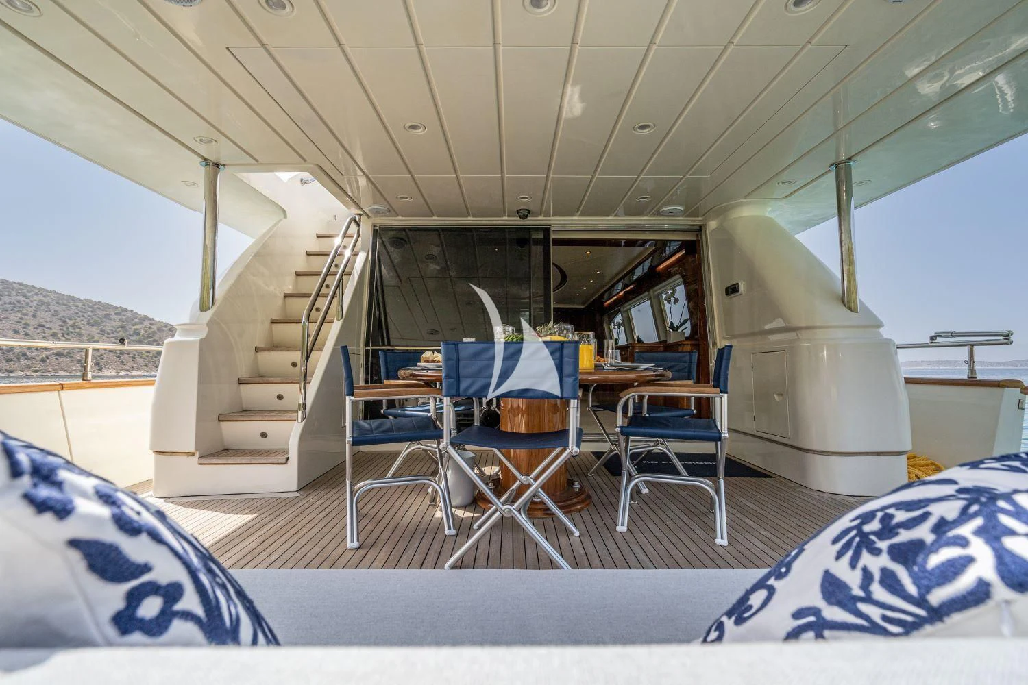 a boat with a table and chairs aboard ESTIA POSEIDON Yacht for Charter