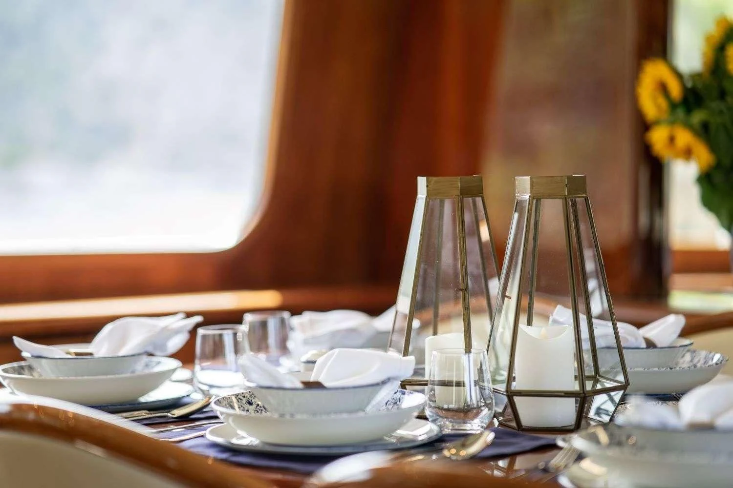 a table with plates and glasses aboard ESTIA POSEIDON Yacht for Charter