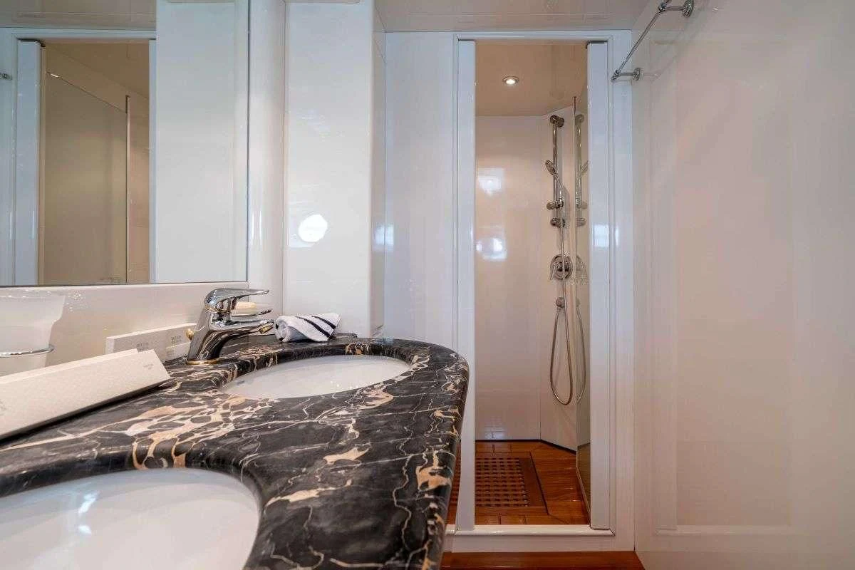 a bathroom with a countertop sink and a shower aboard ESTIA POSEIDON Yacht for Charter