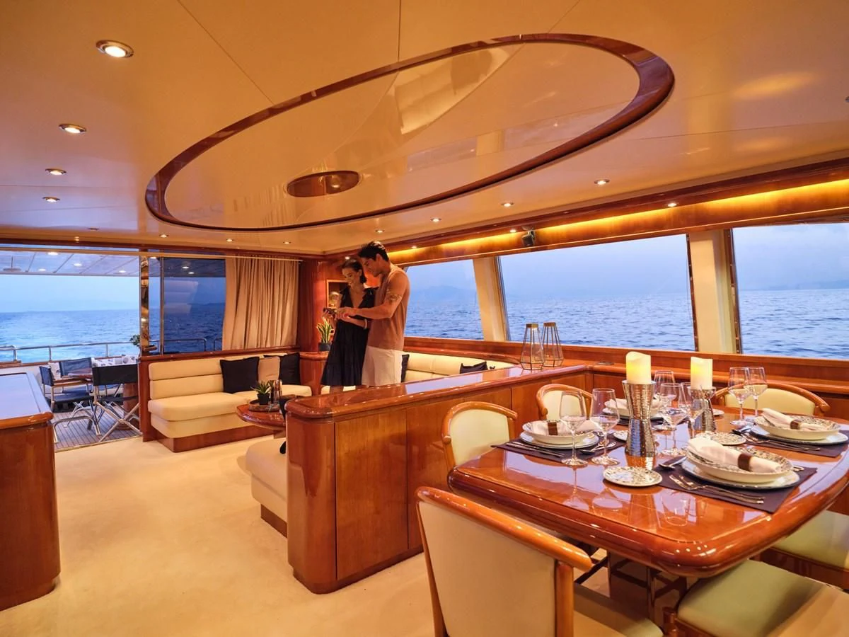 a person standing at a table in a restaurant aboard ESTIA POSEIDON Yacht for Charter