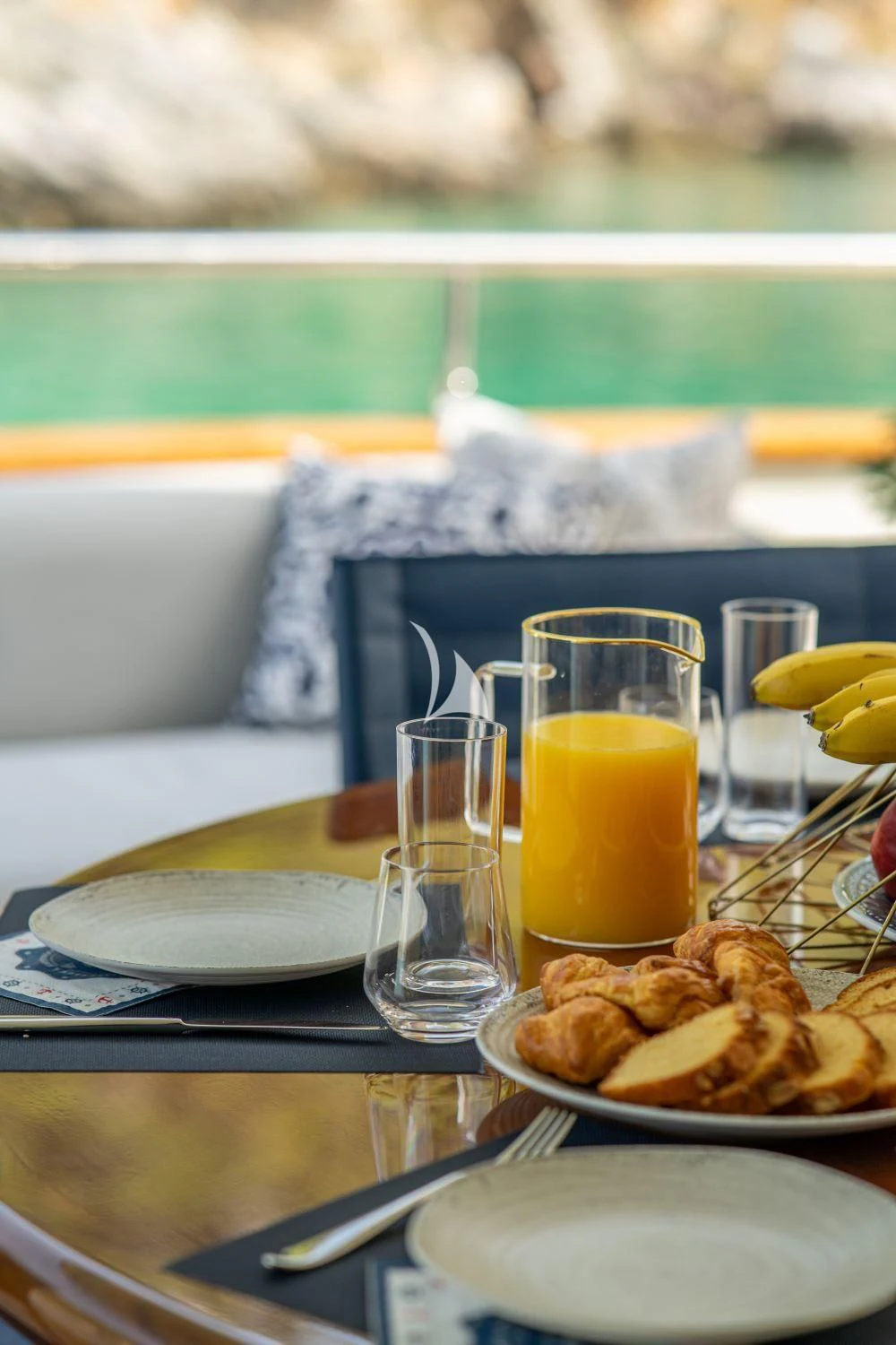 a table with food and drinks on it aboard ESTIA POSEIDON Yacht for Charter