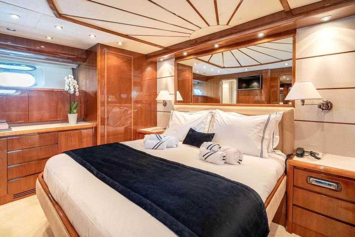 a bed with white sheets aboard ESTIA POSEIDON Yacht for Charter