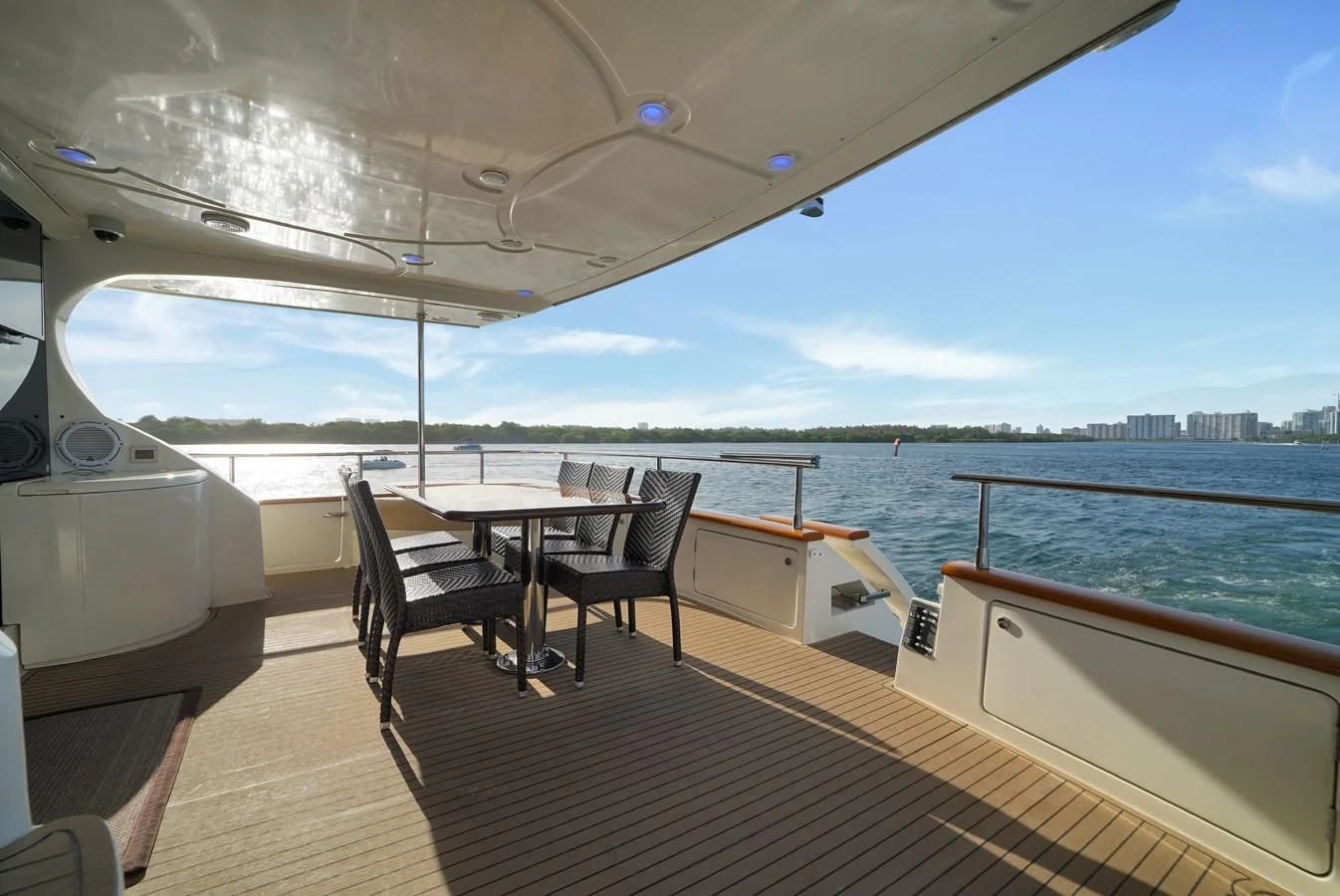 a deck with a table and chairs on it aboard AZIMUT 80 2003 Yacht for Sale