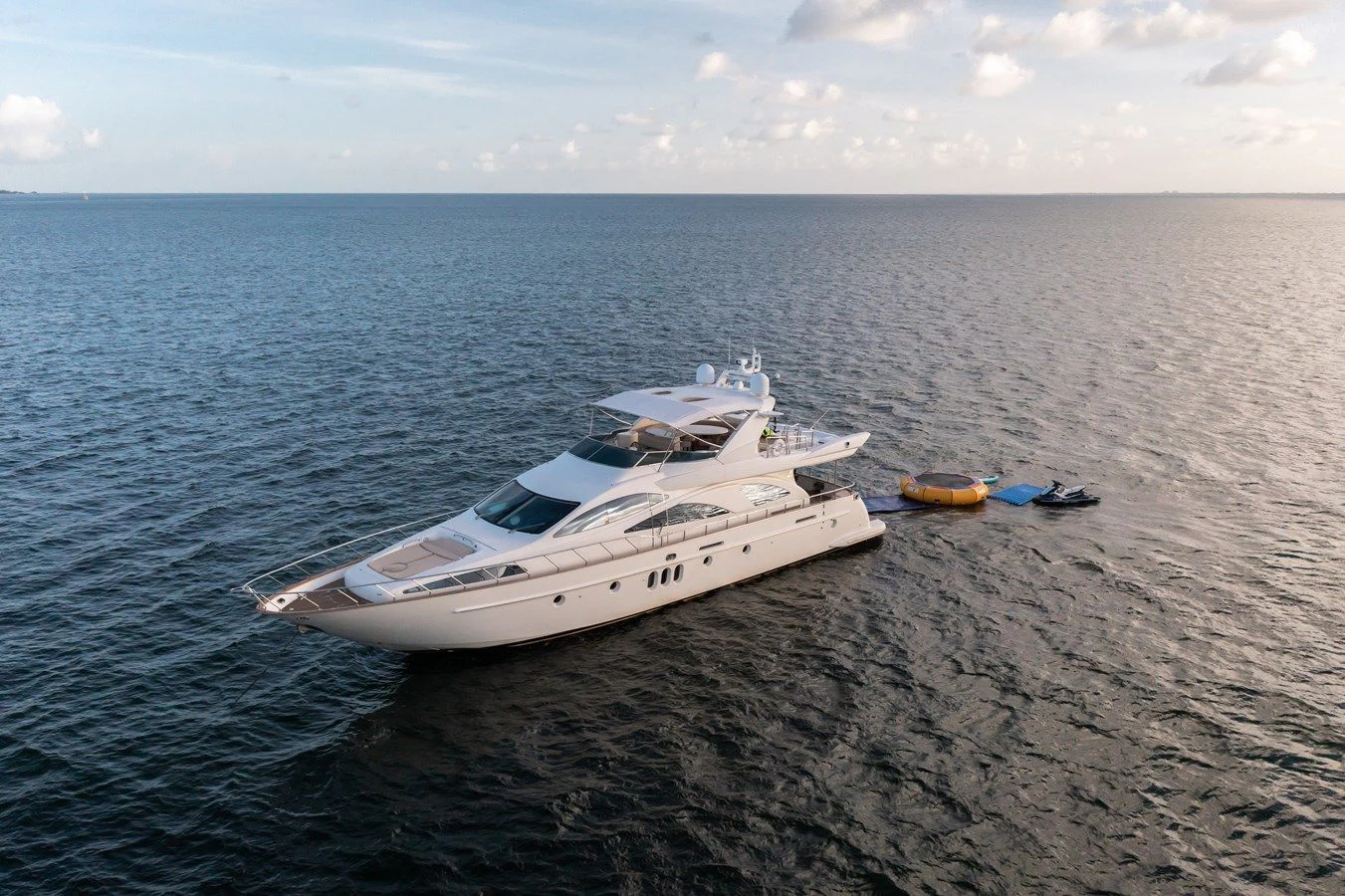 a white boat on a beach aboard AZIMUT 80 2003 Yacht for Sale