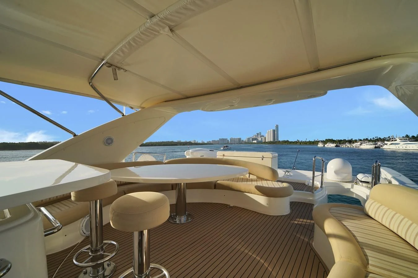 a lounge area with chairs and a large body of water in the background aboard AZIMUT 80 2003 Yacht for Sale