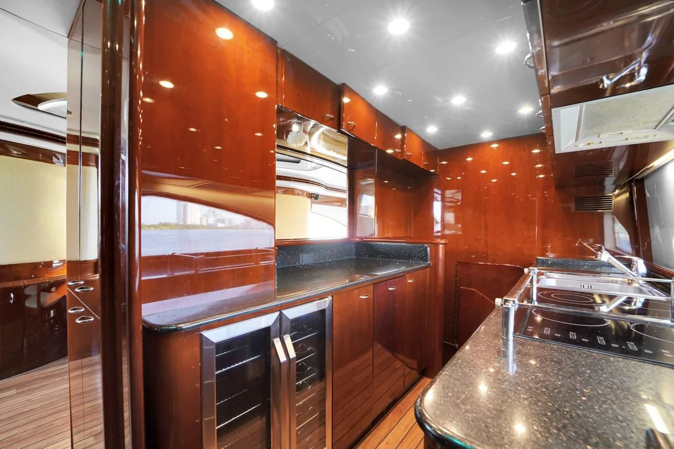 a kitchen with wooden cabinets aboard AZIMUT 80 2003 Yacht for Sale