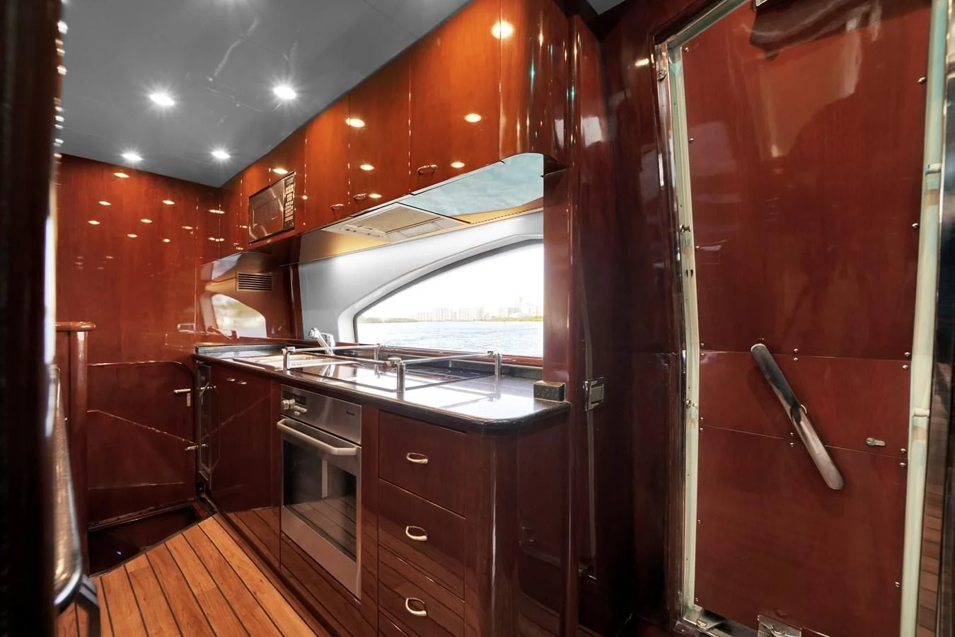 a kitchen with wooden cabinets aboard AZIMUT 80 2003 Yacht for Sale