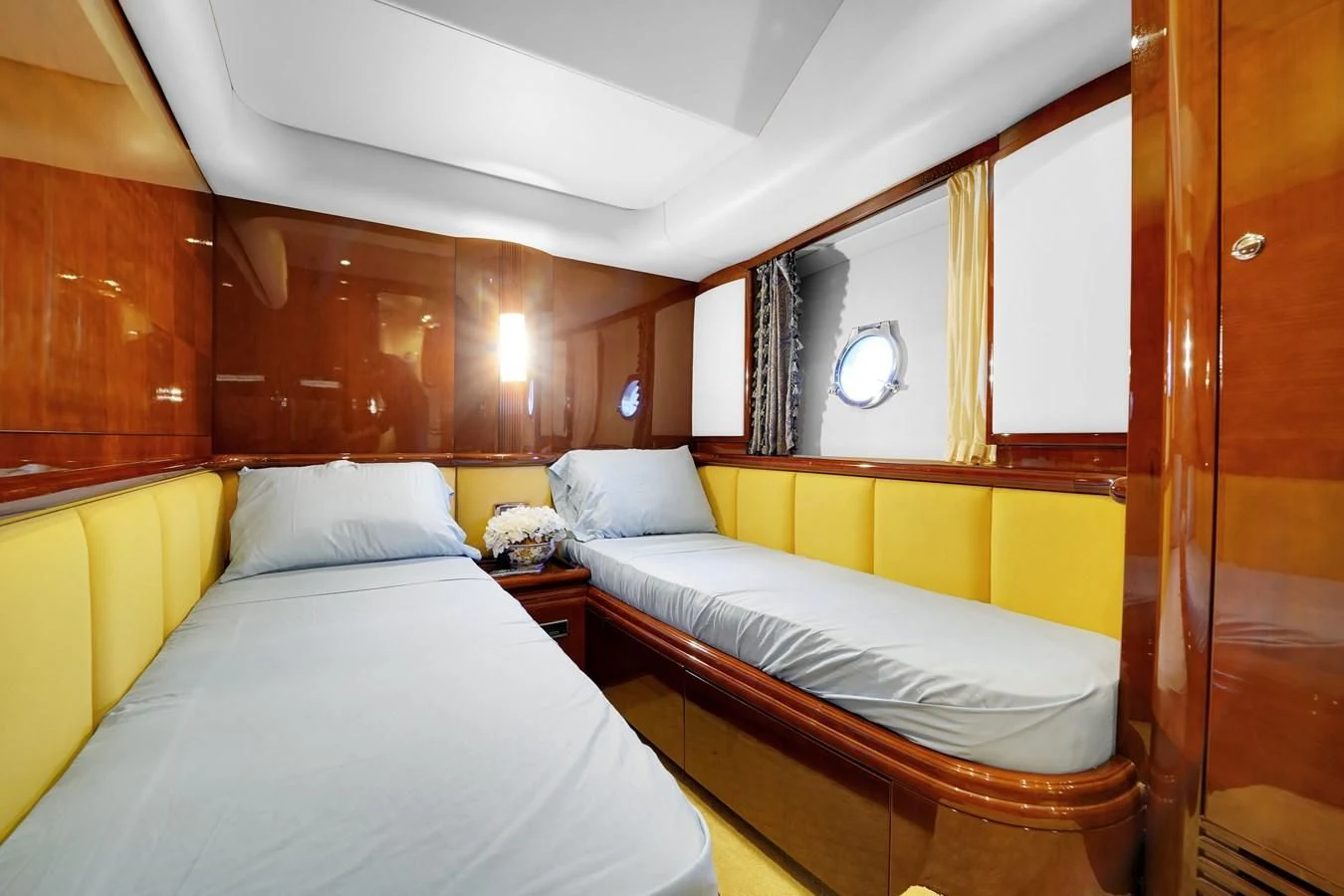 a room with beds and a mirror aboard AZIMUT 80 2003 Yacht for Sale