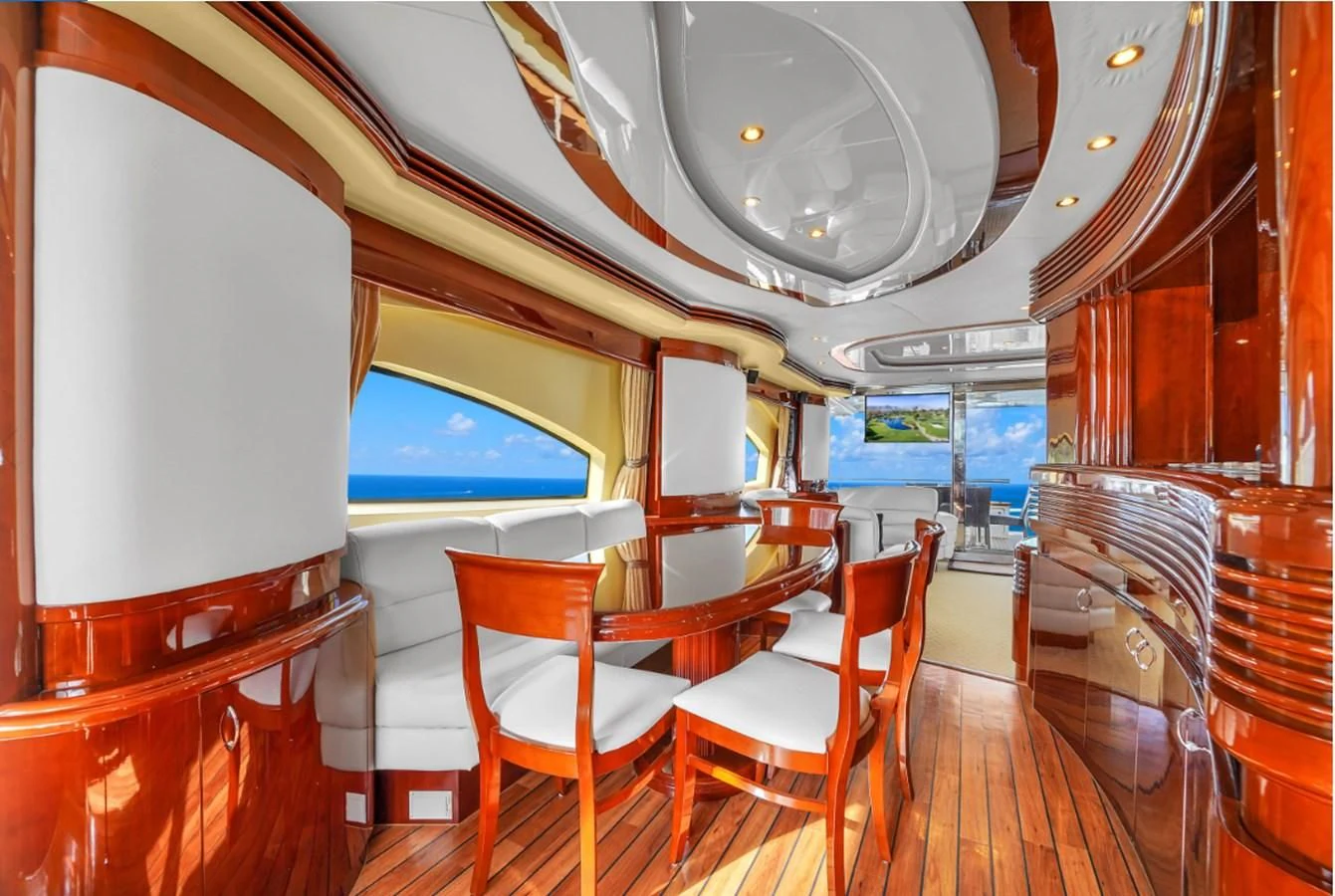 a room with tables and chairs aboard AZIMUT 80 2003 Yacht for Sale