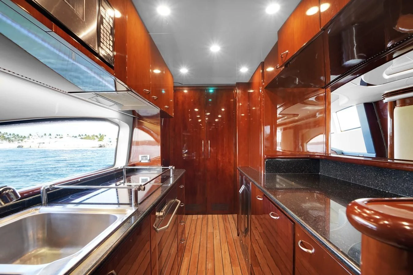 a kitchen with wooden cabinets aboard AZIMUT 80 2003 Yacht for Sale