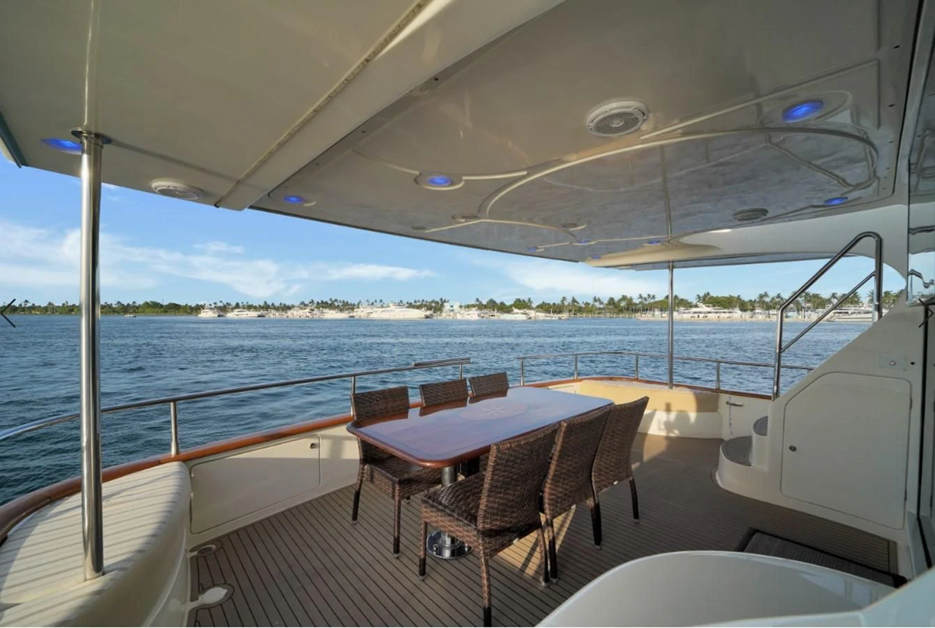 a boat with a table and chairs on the deck aboard AZIMUT 80 2003 Yacht for Sale