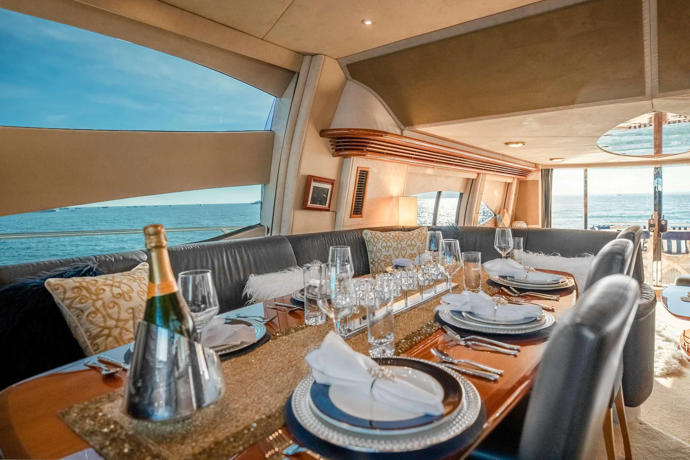 a table with plates and glasses on it aboard LEOLENA Yacht for Sale