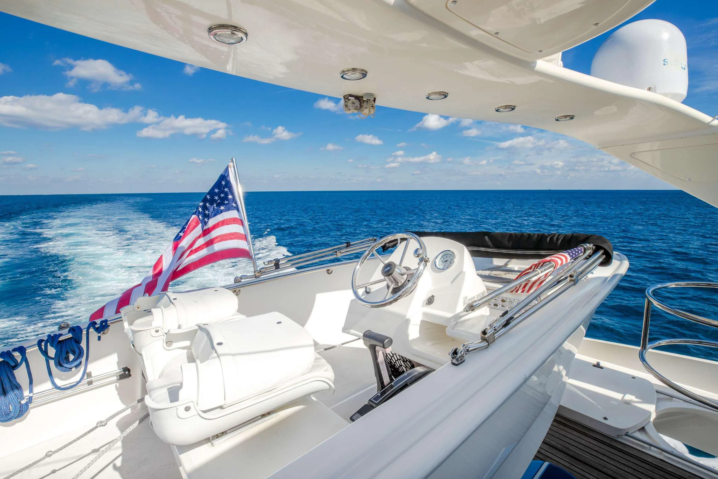 a boat with a flag on the front aboard LEOLENA Yacht for Sale