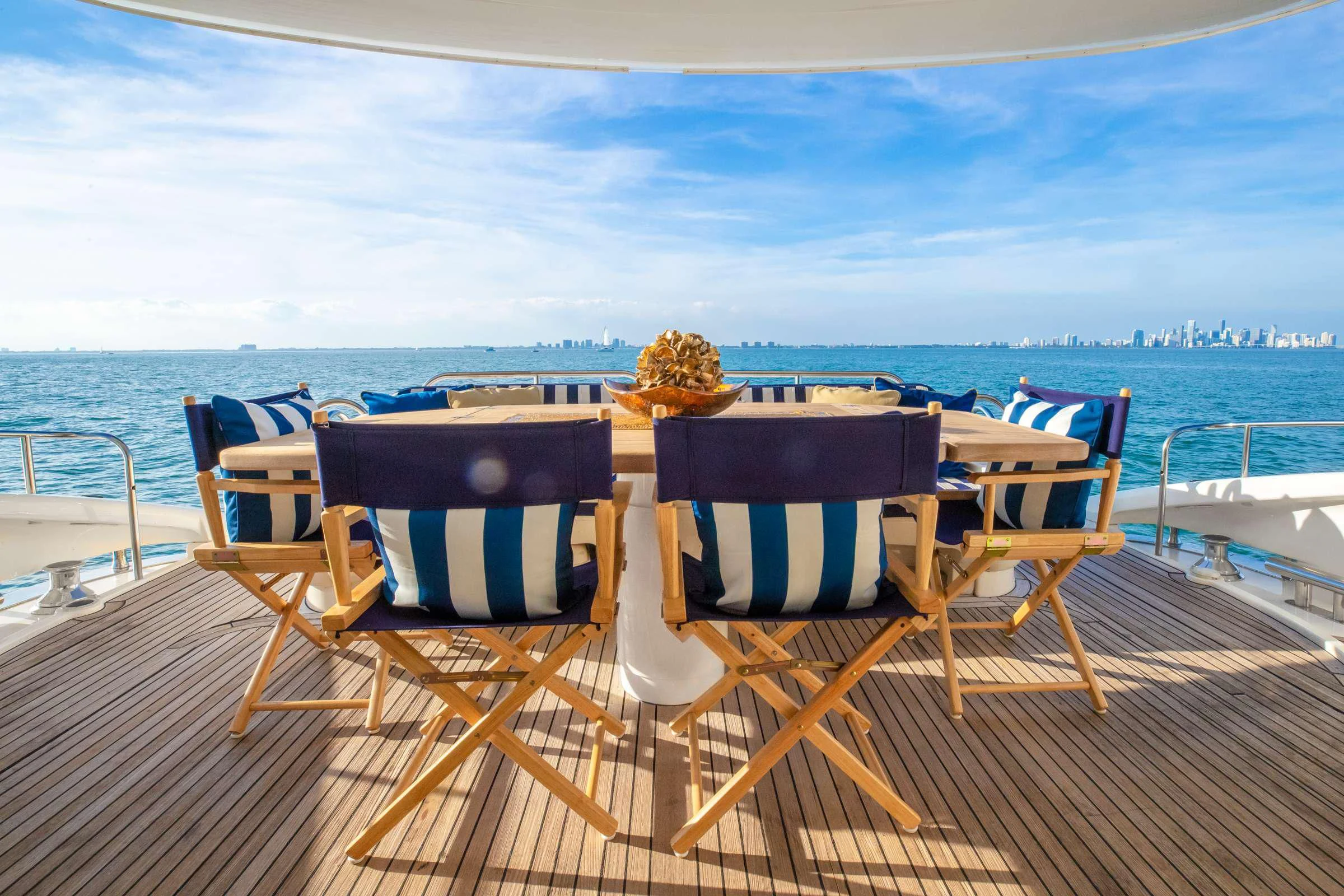 a couple of chairs on a deck overlooking a body of water aboard LEOLENA Yacht for Sale