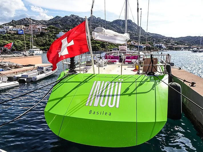 a green boat with a red and white flag on it aboard INOUI Yacht for Sale