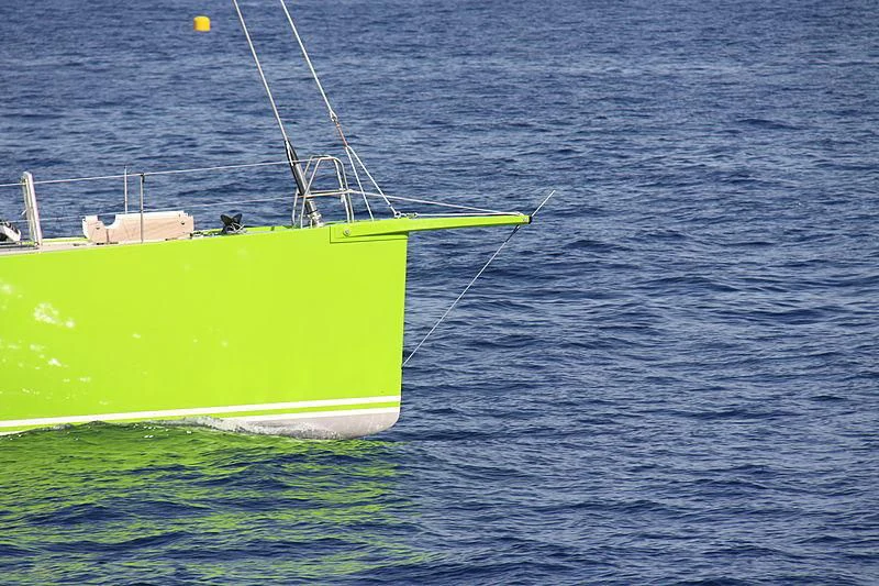 a green and white sailboat on the water aboard INOUI Yacht for Sale