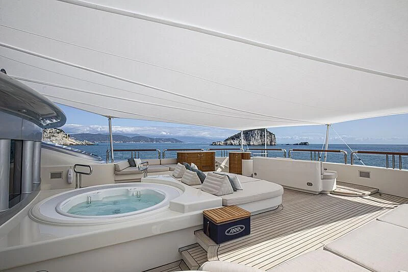 a large white lounge chair on a deck overlooking a large body of water aboard FIREBIRD Yacht for Charter