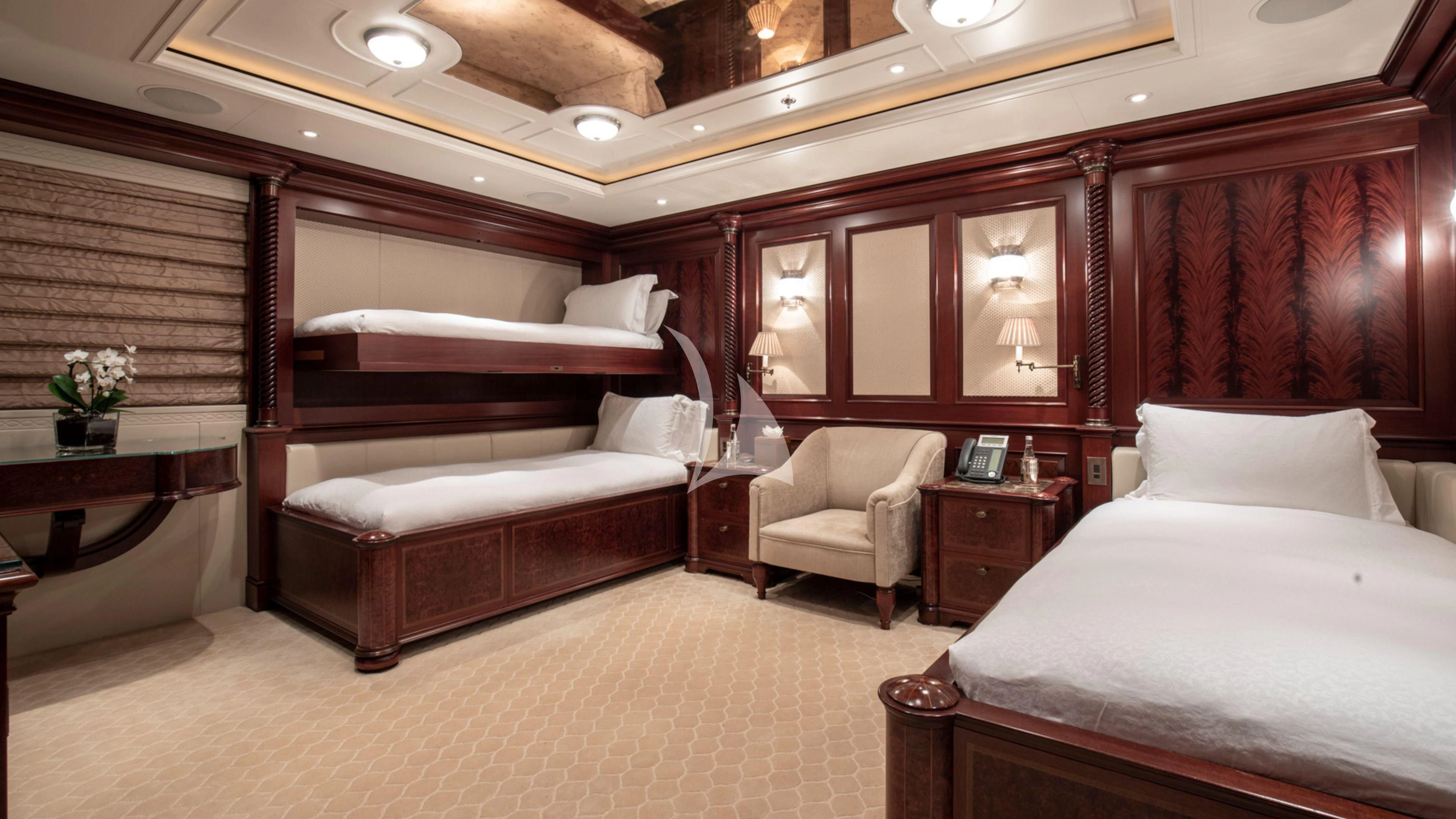 a room with a bed and a chair aboard FIREBIRD Yacht for Charter
