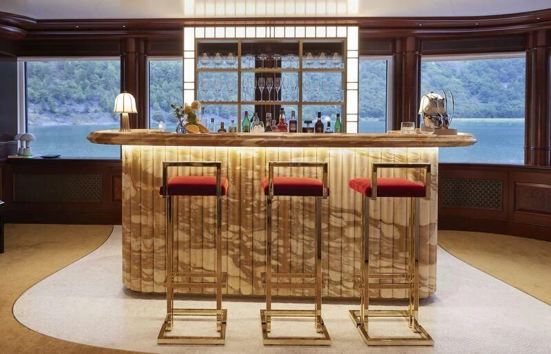 a room with chairs and a table aboard FIREBIRD Yacht for Charter