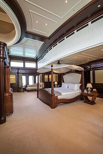 a bedroom with a bed and a canopy aboard FIREBIRD Yacht for Charter